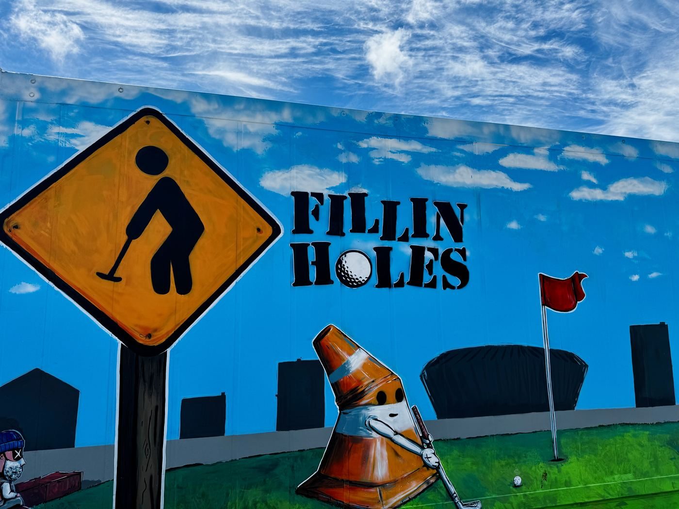 The Fillin' Holes mural on the container wall